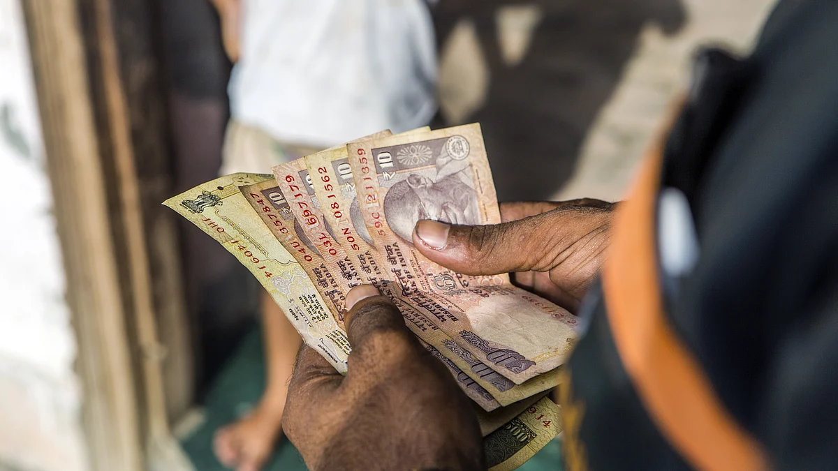 A worker counts Indian rupee banknotes during the delivery of goods (Prashanth Vishwanathan/Bloomberg)