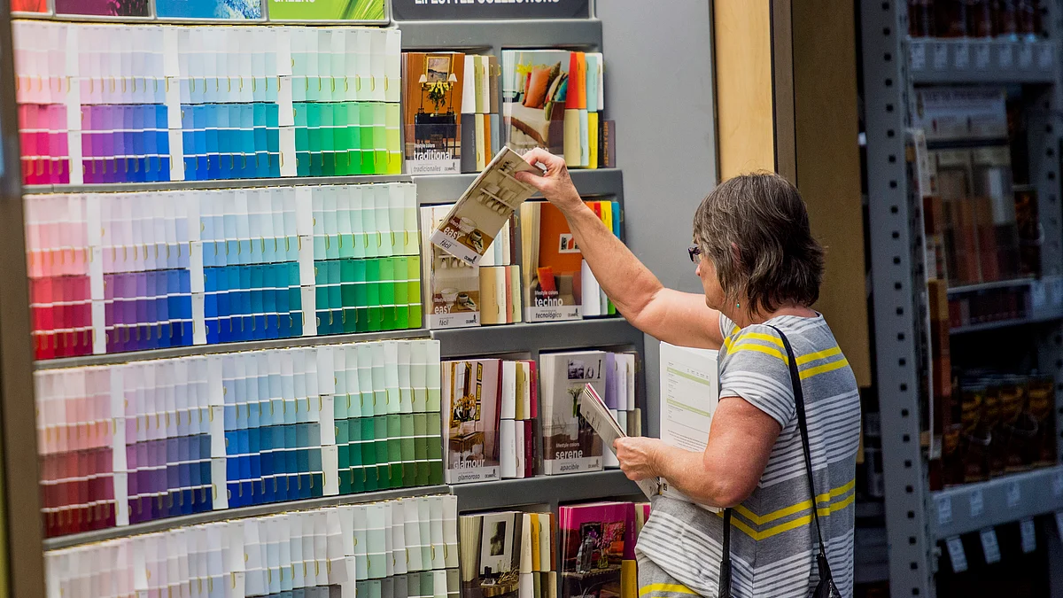 A customer browses paint color samples (Photographer: David Paul Morris/Bloomberg)