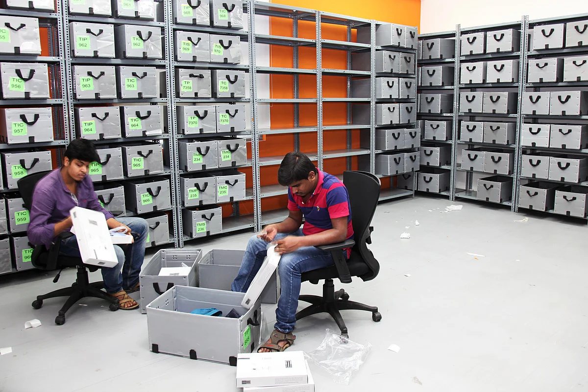 Employees arrange clothing into boxes in the office of Myntra.com, a unit of Flipkart Internet Services Pvt., in Bangaluru. (Photographer: Namas Bhojani/Bloomberg)