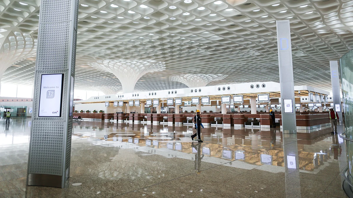 A worker walks through Terminal 2 of the Chhatrapati Shivaji International Airport (Photographer: Dhiraj Singh/Bloomberg)