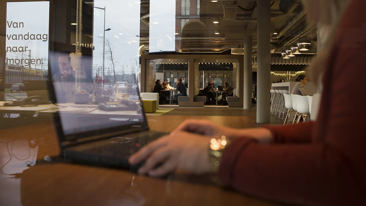 An employee works on a laptop computer inside a store. (Photographer: Jasper Juinen/Bloomberg)