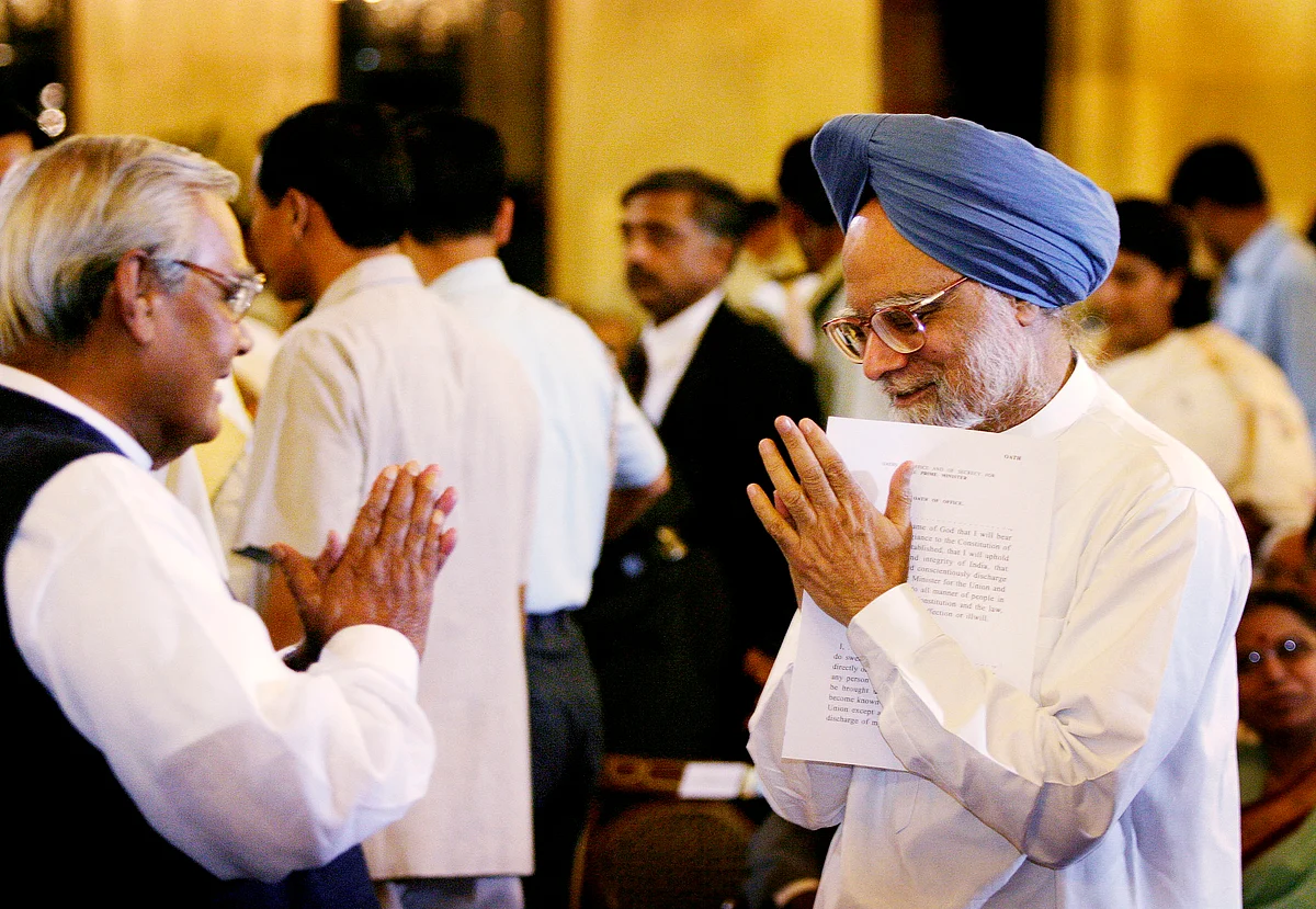 Manmohan Singh, right, greets then outgoing Prime Minister Atal Bihari Vajpayee, left, before Singh was sworn in as the new Prme Minister of India at the Presidential Palace in New Delhi Saturday, May 22, 2004. (Photographer: Amit Bhargava/Bloomberg News)