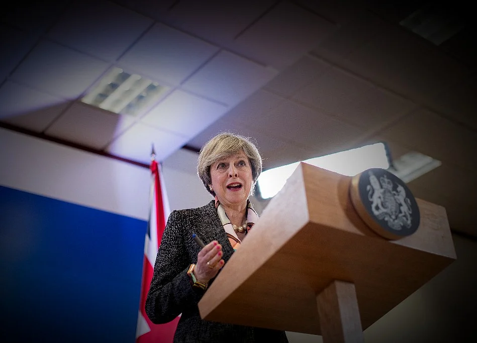May Vows to Carry On as Brexit’s Hardliners Try to Topple Her
