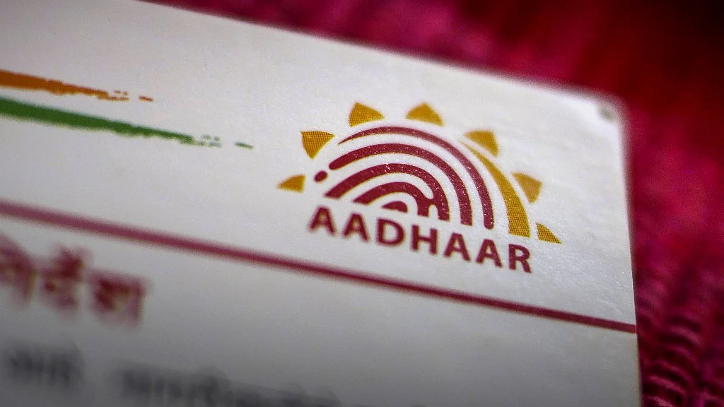 An Aadhaar biometric identity card, issued by the Unique Identification Authority of India (UIDAI), is arranged for a photograph in Mumbai, India (Photographer: Dhiraj Singh/Bloomberg) 