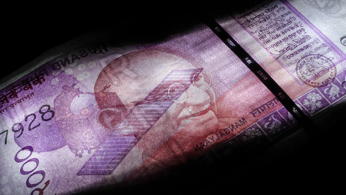 An Indian two thousand rupee banknote is arranged for a photograph in Mumbai, India, (Photographer: Dhiraj Singh/Bloomberg)