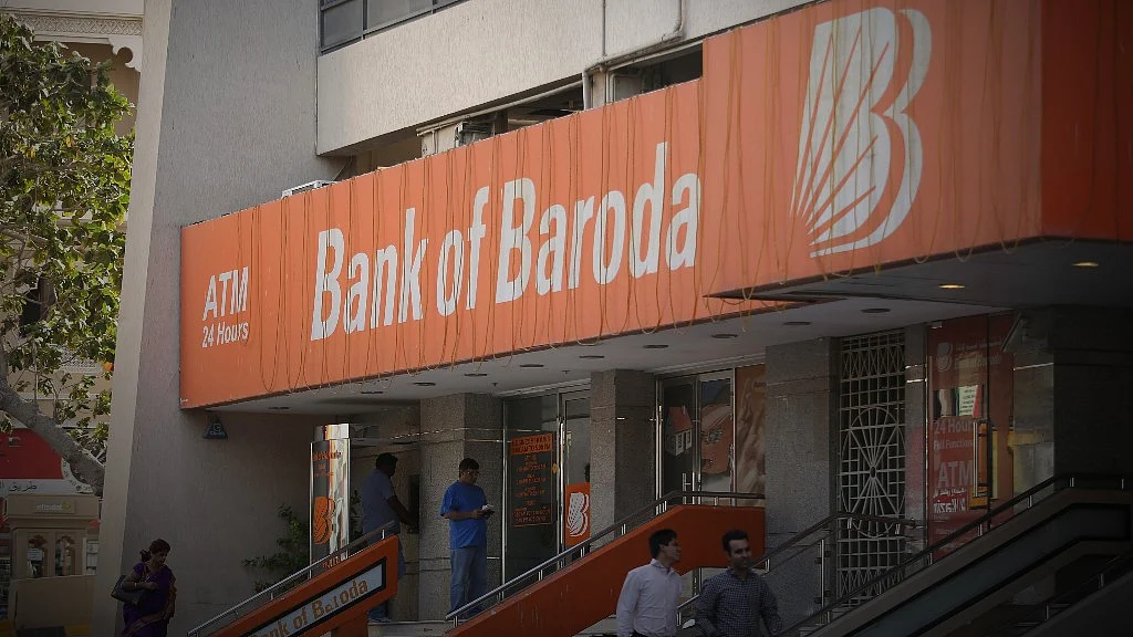 Pedestrians pass a Bank of Baroda bank branch in Dubai, United Arab Emirates. (Photographer: Chris Ratcliffe/Bloomberg)