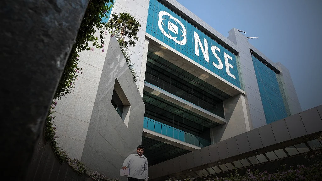 An employee walks along a pathway at the National Stock Exchange (NSE) in Mumbai, India (Photographer: Dhiraj Singh/Bloomberg)