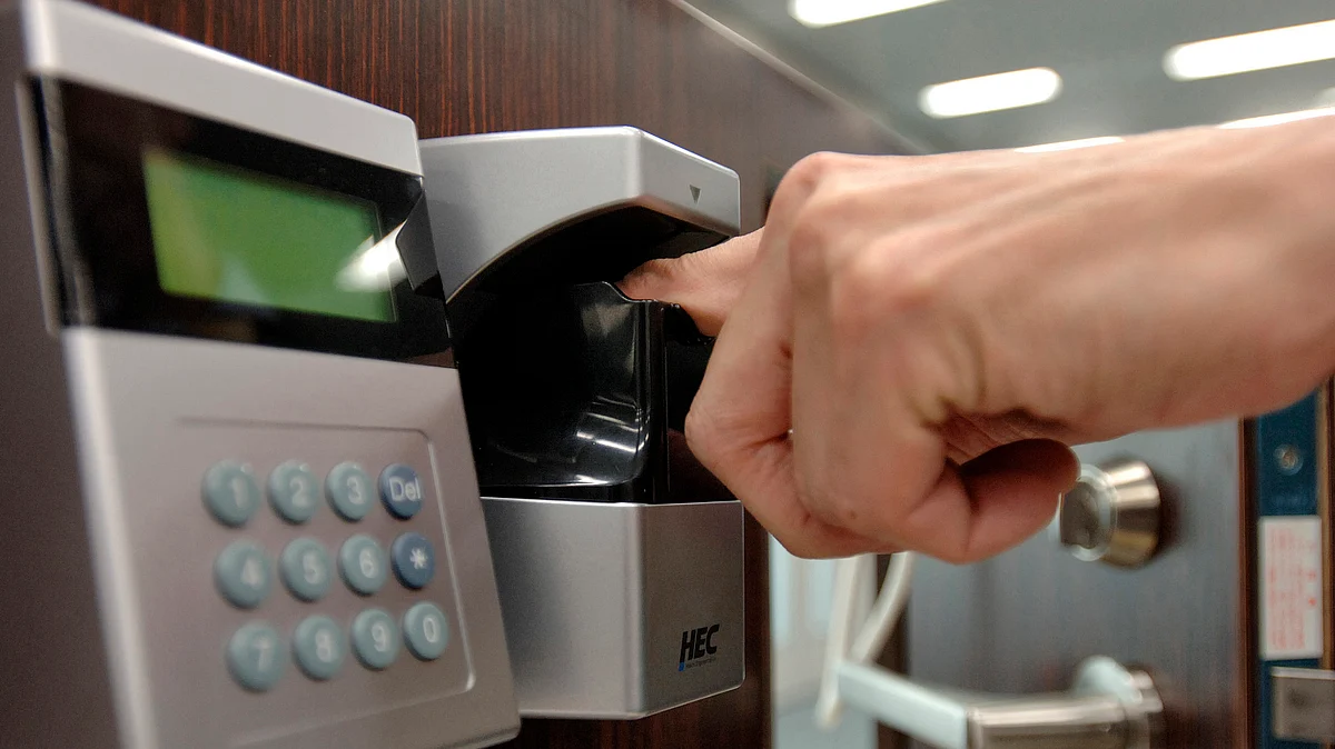 An employee demonstrates a biometric door lock that scans the veins inside a user’s finger to confirm their identity. ( Photographer: Michael Caronna / Bloomberg News)