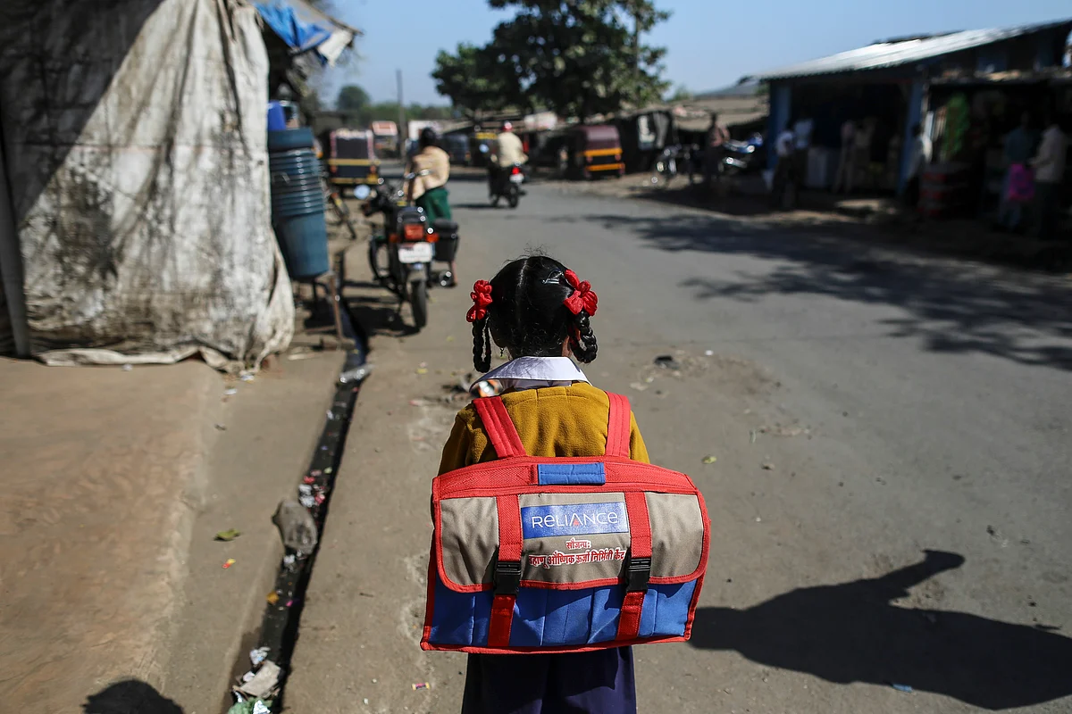 A schoolgirl walks along Dahanu Road in Kainad, Maharashtra, India. (Photographer: Dhiraj Singh/Bloomberg)
