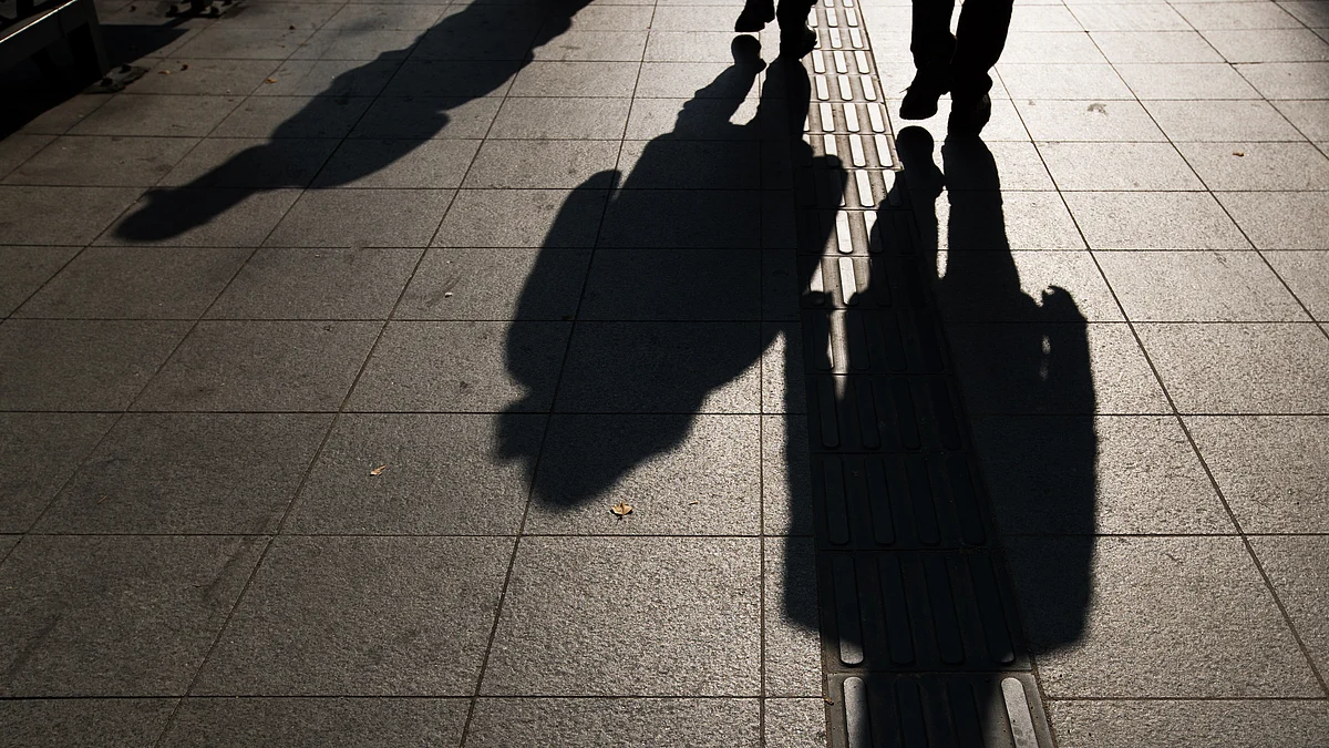 The shadows of pedestrians are cast on a sidewalk in Seoul, South Korea. (Photographer: SeongJoon Cho/Bloomberg)