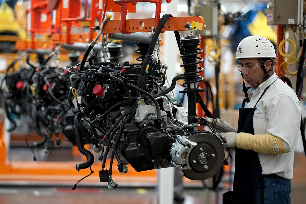 An employee works on the assembly line producing the new Ford Fiesta car, at the Ford Motor plant in Cuautitlan Izcalli, Mexico, on May 11, 2010. (Photographer: Susana Gonzalez/Bloomberg)