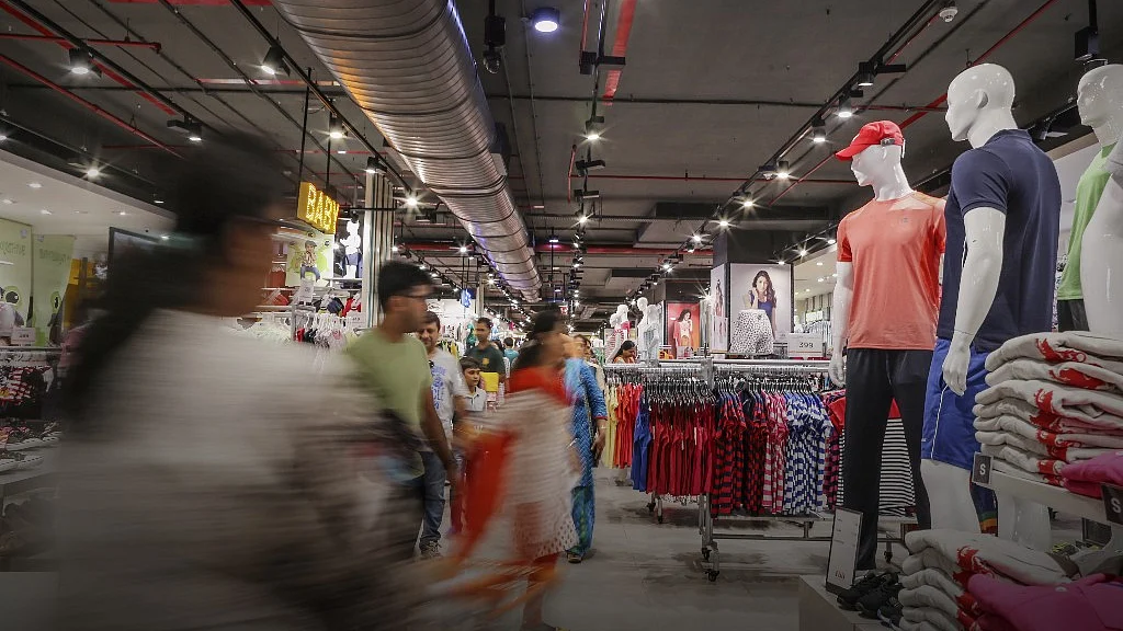 <div class="paragraphs"><p> Customers walk past clothes on display at hypermarket, operated by Future Retail (Photographer: Dhiraj Singh/Bloomberg)</p></div>