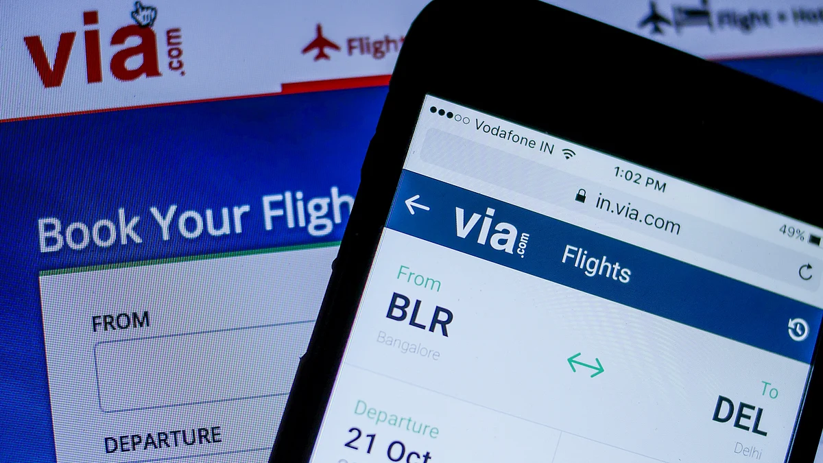 The Via.com website, operated by Flightraja Travels Pvt., is displayed on a smartphone, right, and a laptop computer in this arranged photograph taken in Mumbai, India. (Photographer: Namas Bhojani/Bloomberg)
