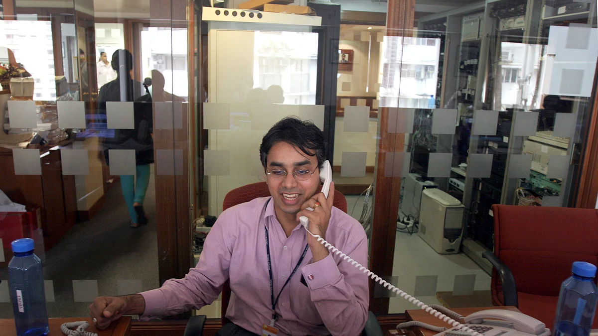 A stock broker speaks on a telephone in Mumbai. (Photographer: Prashanth Vishwanathan/Bloomberg News)