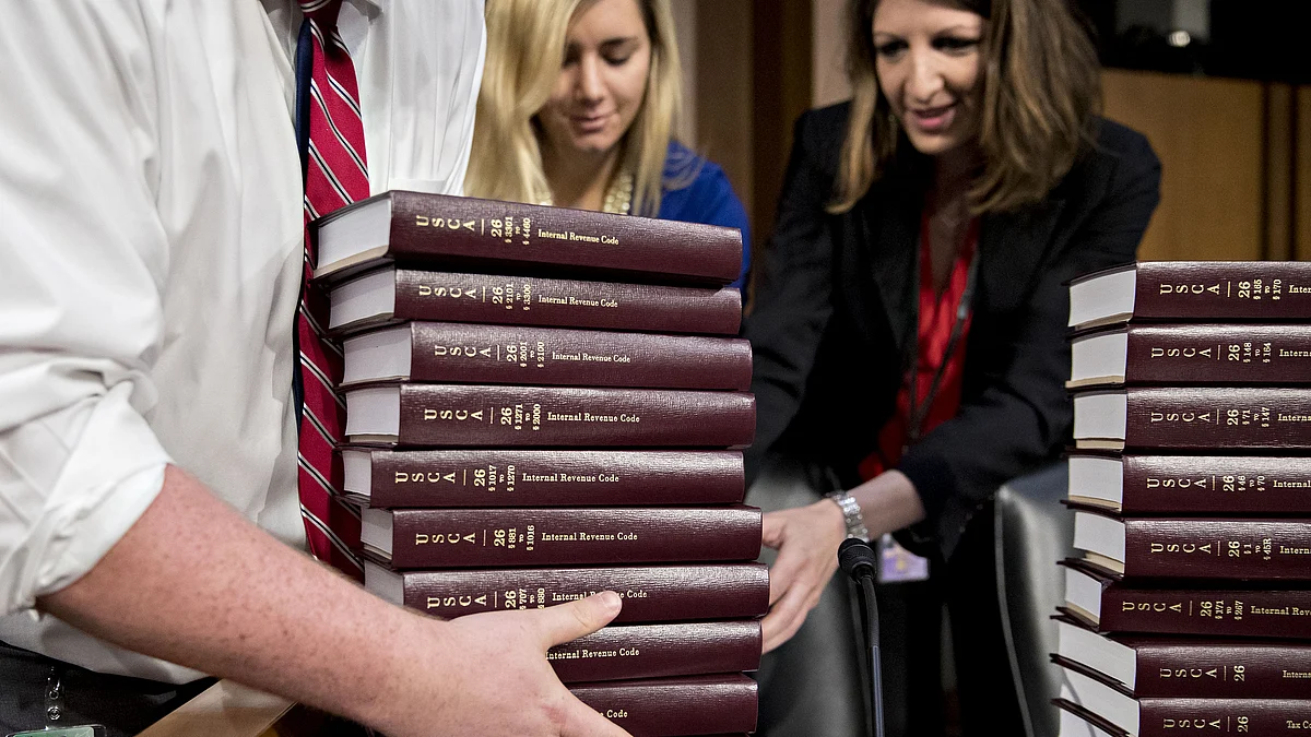 Lawyers arranging Internal Revenue Code books before a Senate hearing in Washington, D.C. (Photographer: Andrew Harrer/Bloomberg)