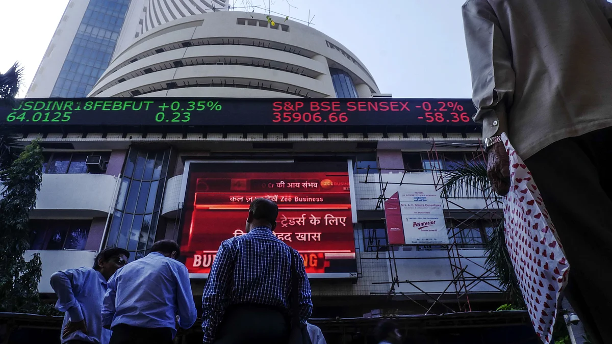 Pedestrians look up at an electronic ticker board showing a budget news report outside the Bombay Stock Exchange (BSE) in Mumbai, India. (Photographer: Dhiraj Singh/Bloomberg)