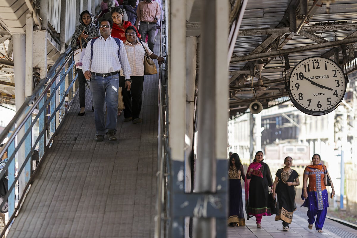 Commuters walk down a ramp towards a platform at Mumbai Central Train Station in Mumbai, India. (Photographer: Dhiraj Singh/Bloomberg) &nbsp;