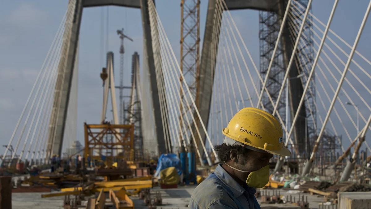 A laborer works on the Bandra-Worli sea link in Mumbai. (Photographer: Adeel Halim/Bloomberg News)