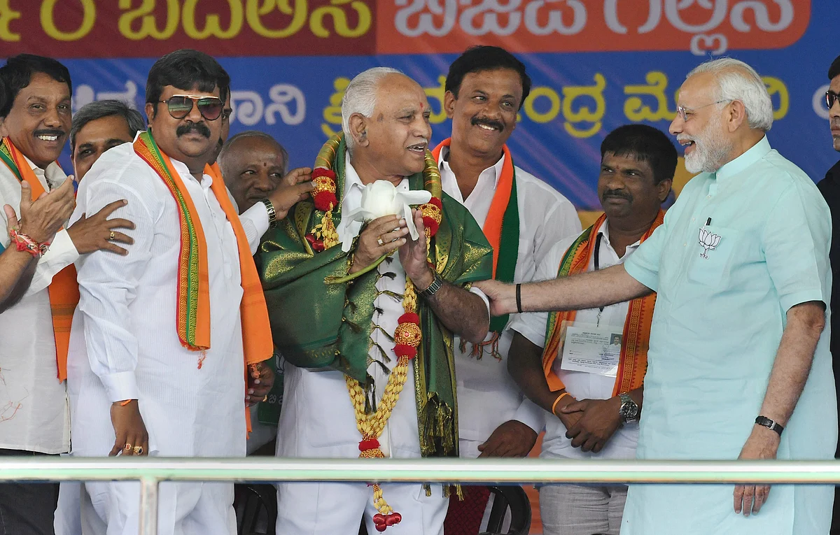 Prime Minister Narendra Modi and BJP’s chief ministerial candidate BS Yeddyurappa share a lighter moment during Karnataka election campaign rally at Chamarajanagar on Tuesday. (Source: PTI)
