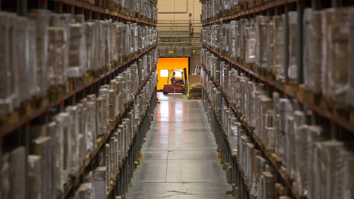An employee drives a forklift truck past storage aisles containing retail goods for shipping in the Ikea AB distribution center in Yesipovo village, near Moscow. (Photographer: Andrey Rudakov/Bloomberg)