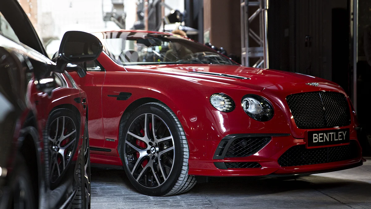 A Bentley Motors Ltd. 2017 Continental Supersports convertible vehicle sits on display next to a Supersports coupe vehicle. (Photographer: Andrew Harrer/Bloomberg)
