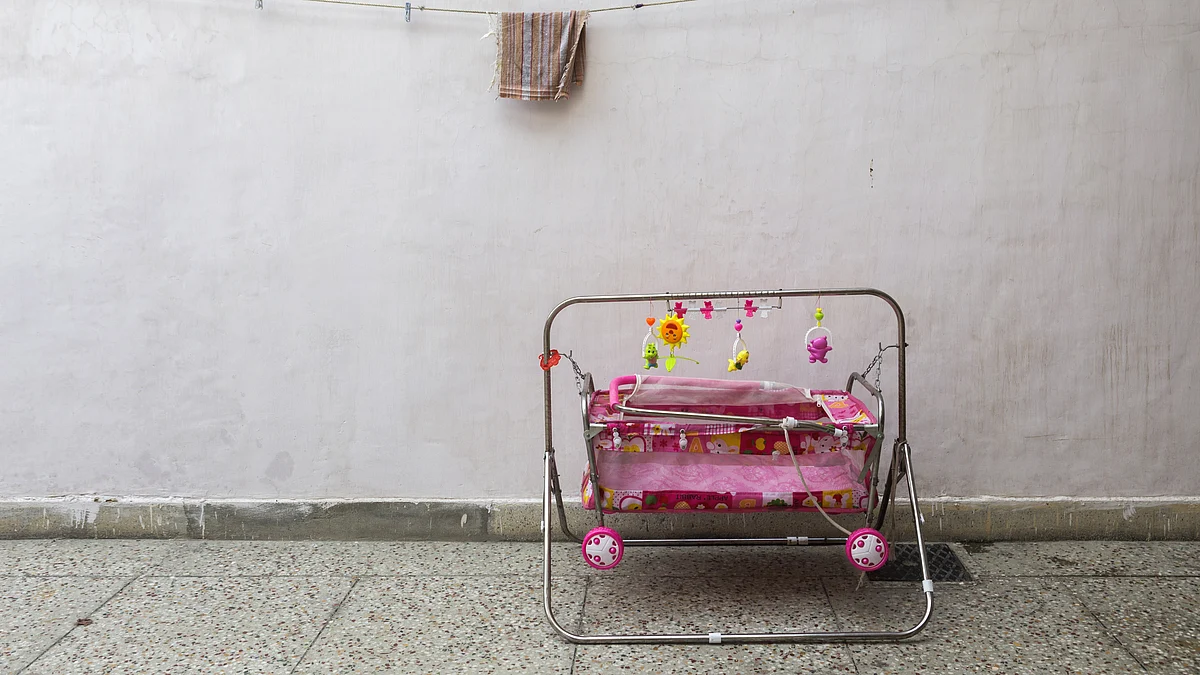 A baby’s cot sits on the ground (Photographer: Prashanth Vishwanathan/Bloomberg)