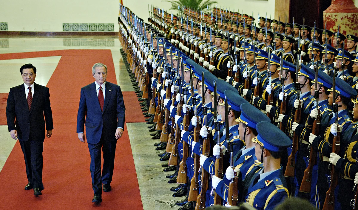 U.S. President George W. Bush reviews an honor guard with Chinese President Hu Jintao, at the Great Hall of the People in Beijing, China, November 20, 2005. (Photographer: Daniel Acker/Bloomberg News)