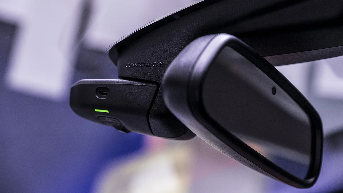 The lens of a built-in driver’s-view camera sits on the rear view mirror. (Photographer: Balint Porneczi/Bloomberg)