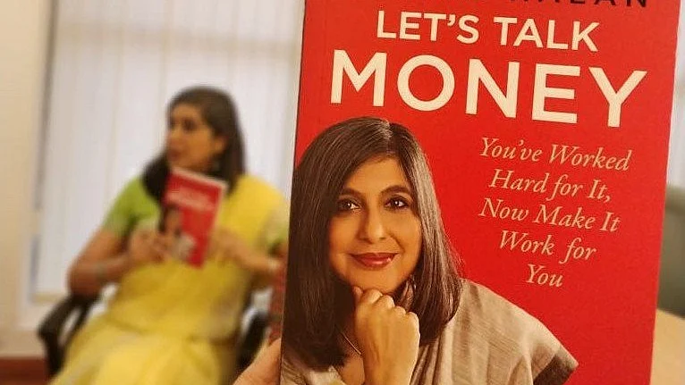 A copy of Monika Halan’s book Let’s Talk Money with the author seated in the background. (Image: Monika Halan)