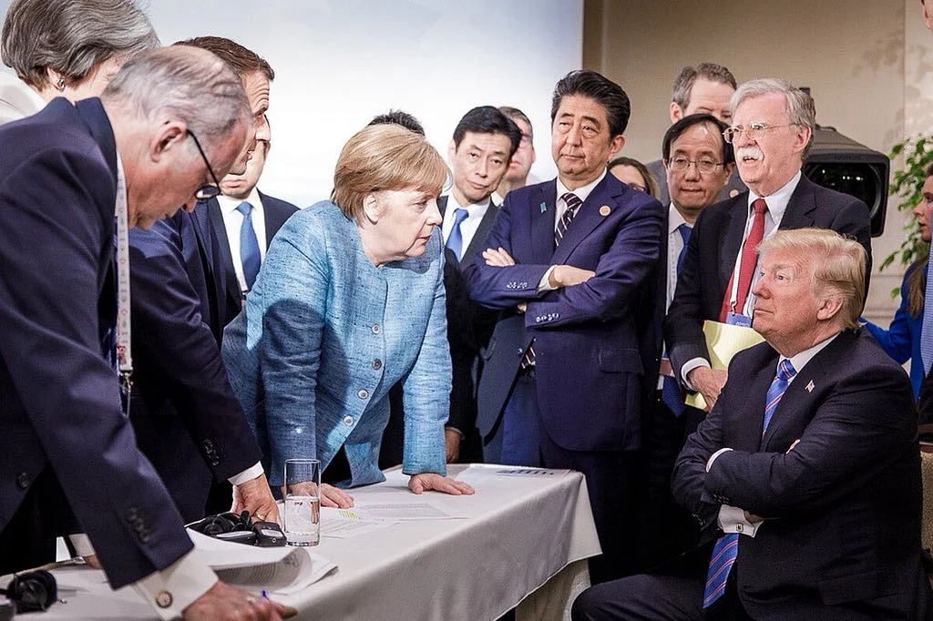 U.S. President Donald Trump with German Chancellor Angela Merkel, French President Emmanuel Macron and British Prime Minister Theresa May, as Japanese Prime Minister Shinzo Abe, and U.S. NSA John Bolton look on, at the G7 Summit in Quebec, Canada, on June 9, 2018. (Photograph: German Federal Press Office/Twitter)