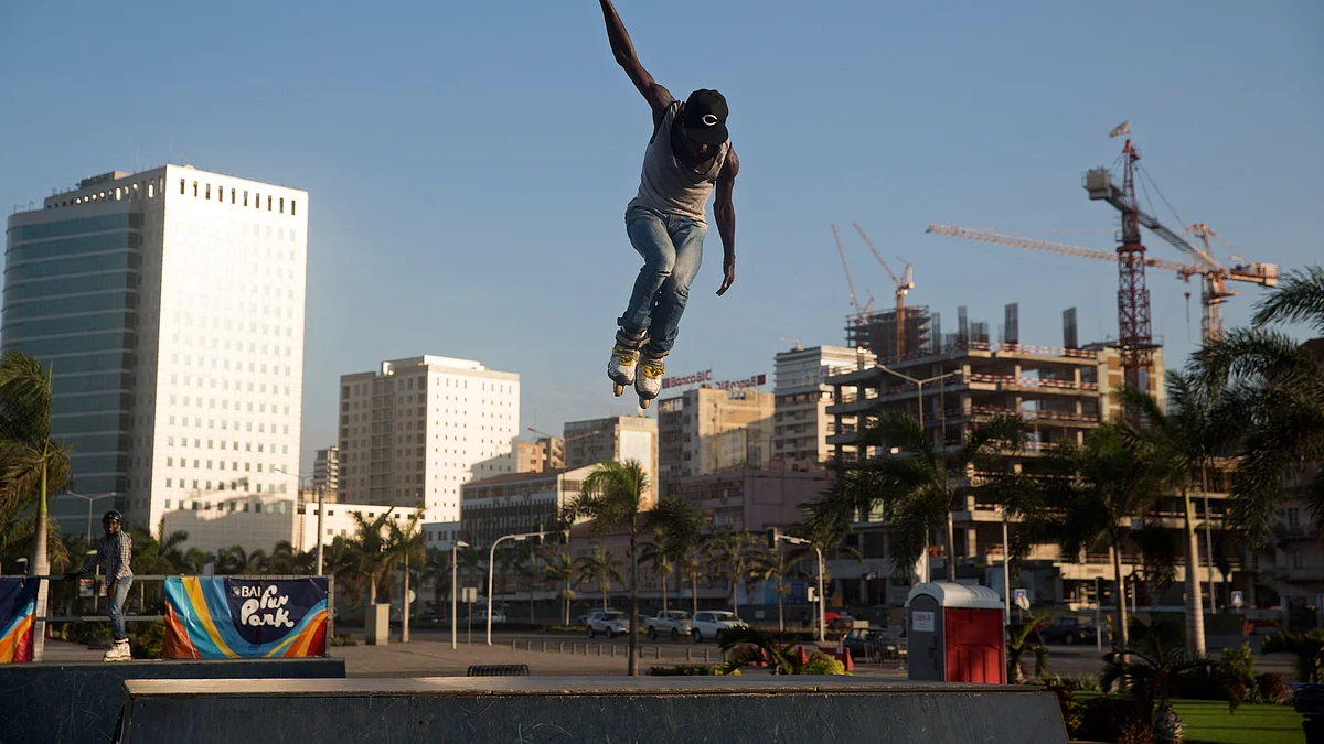 A local youth jumps high in the air (Photographer: Simon Dawson/Bloomberg)