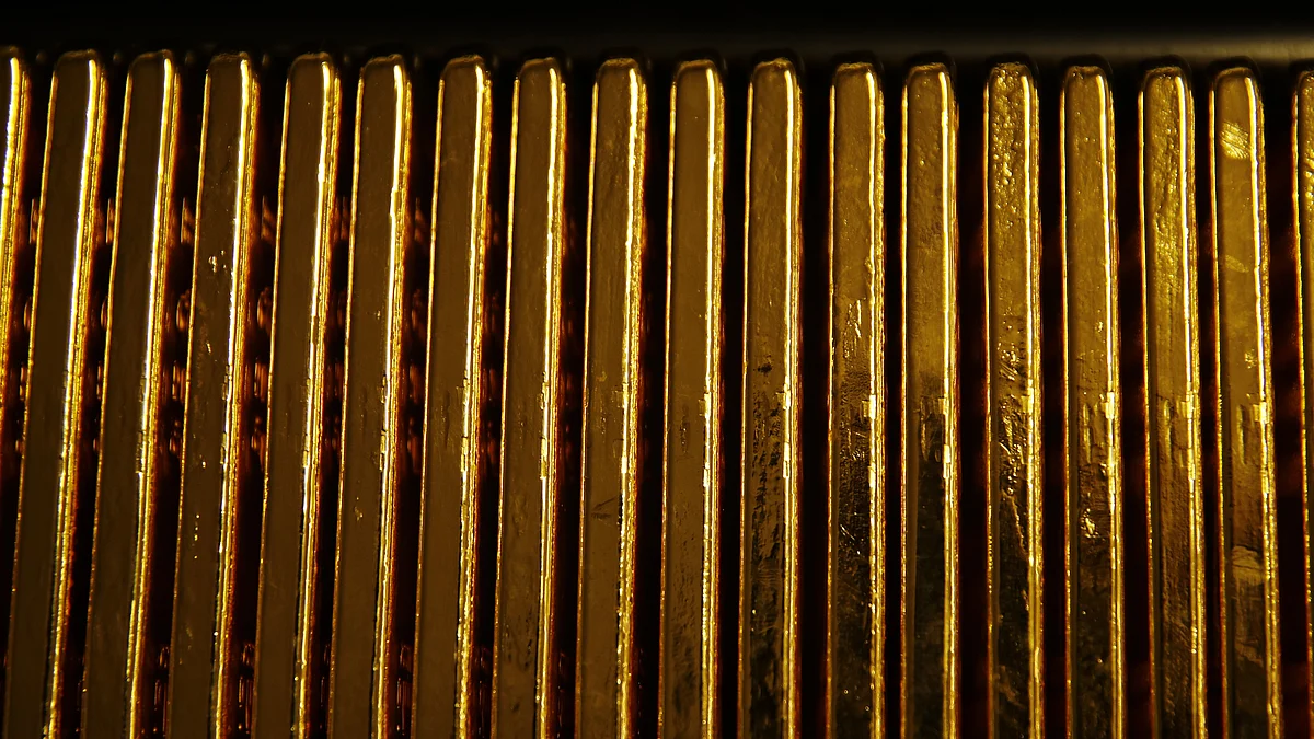 One kilogram bars of gold sit stacked in a row at a refinery in Switzerland. (Photographer: Stefan Wermuth/Bloomberg)