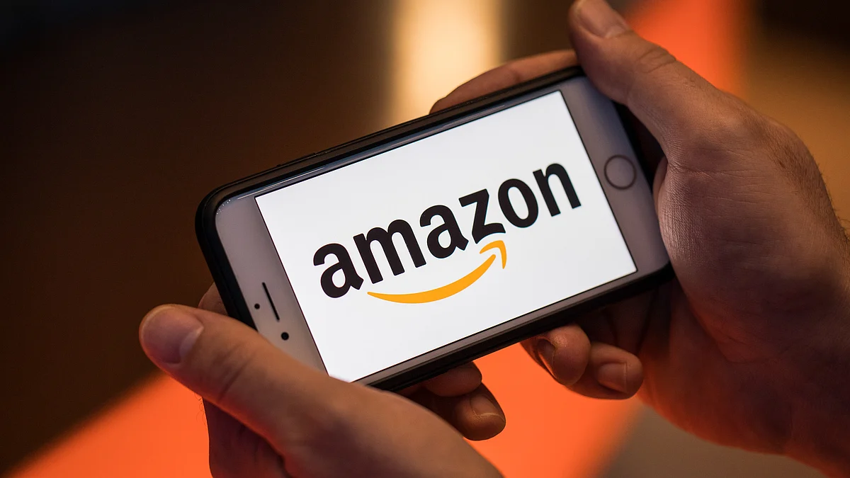 The logo of Amazon.com Inc. sits on an Apple Inc. iPhone smartphone in this arranged photograph. (Photographer: Jason Alden/Bloomberg)