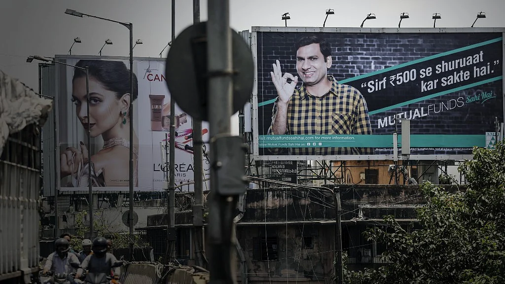 An advertisement for the Mutual Funds Sahi Hai campaign by the Association of Mutual Funds in India (AMFI) is displayed near a highway in Mumbai, India. (Photographer: Dhiraj Singh/Bloomberg)