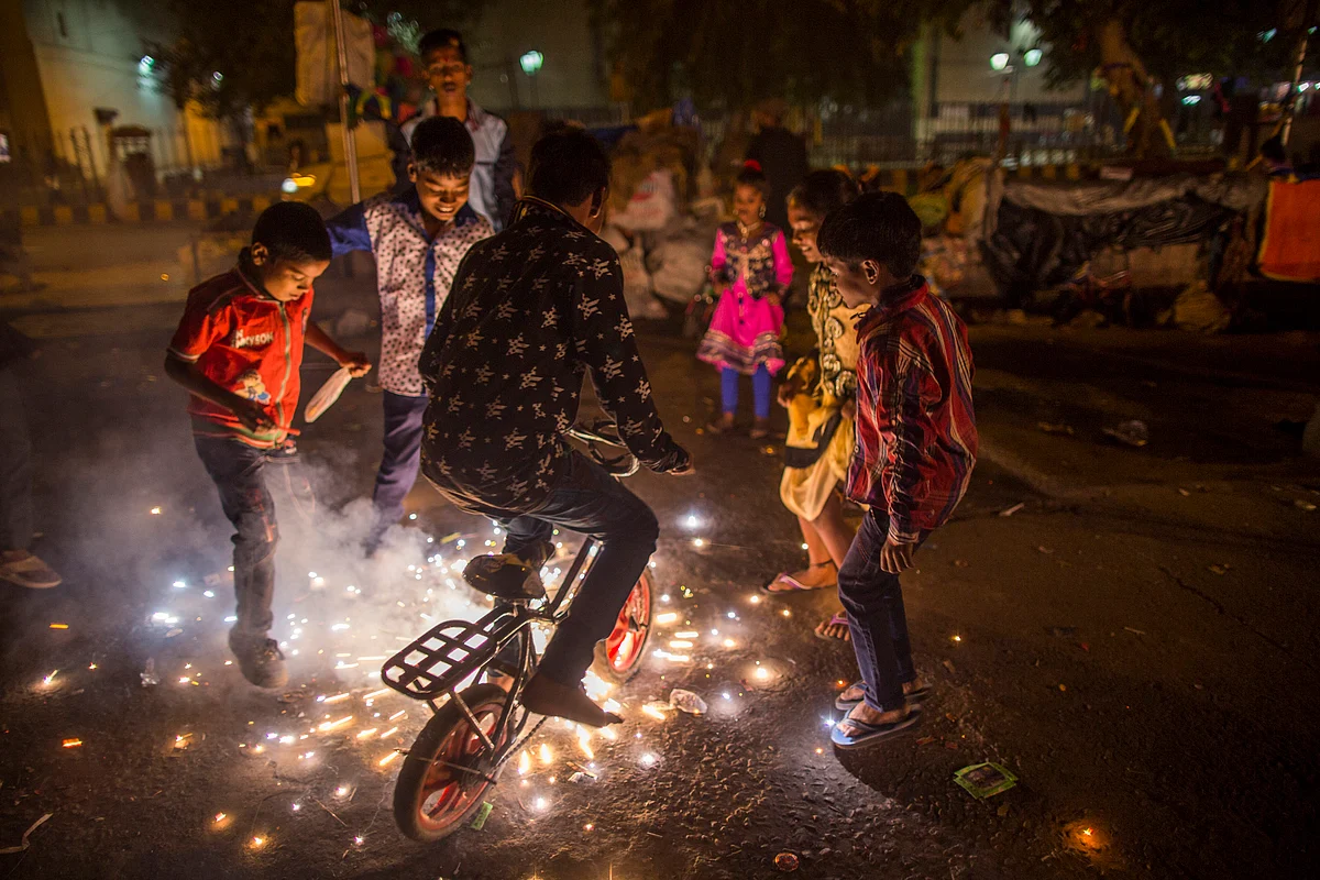 Children light fireworks during Diwali celebrations in Delhi. Photographer: Prashanth Vishwanathan/Bloomberg