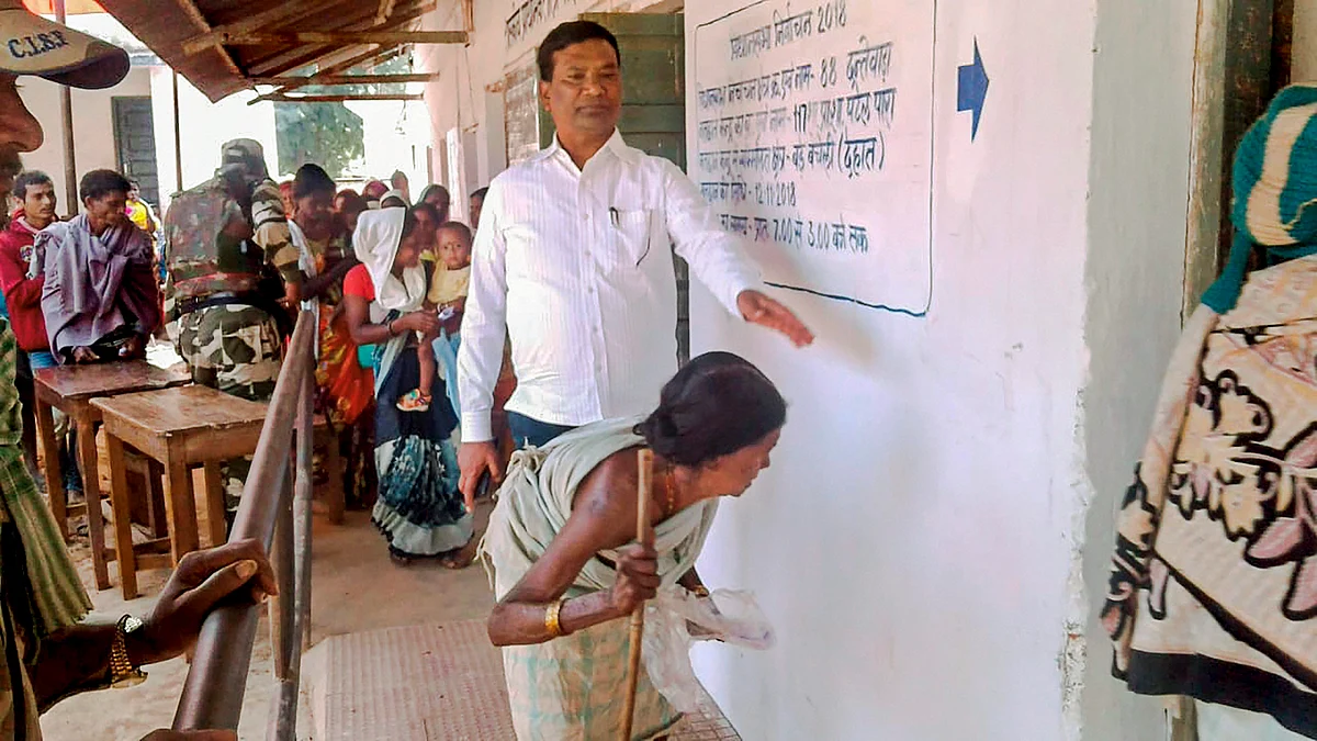 An elderly woman along with other voters waits to cast her vote at a polling station, at Solana, Hamirgarh, Chhattisgarh, on Nov. 12, 2018. (Photograph: PTI)