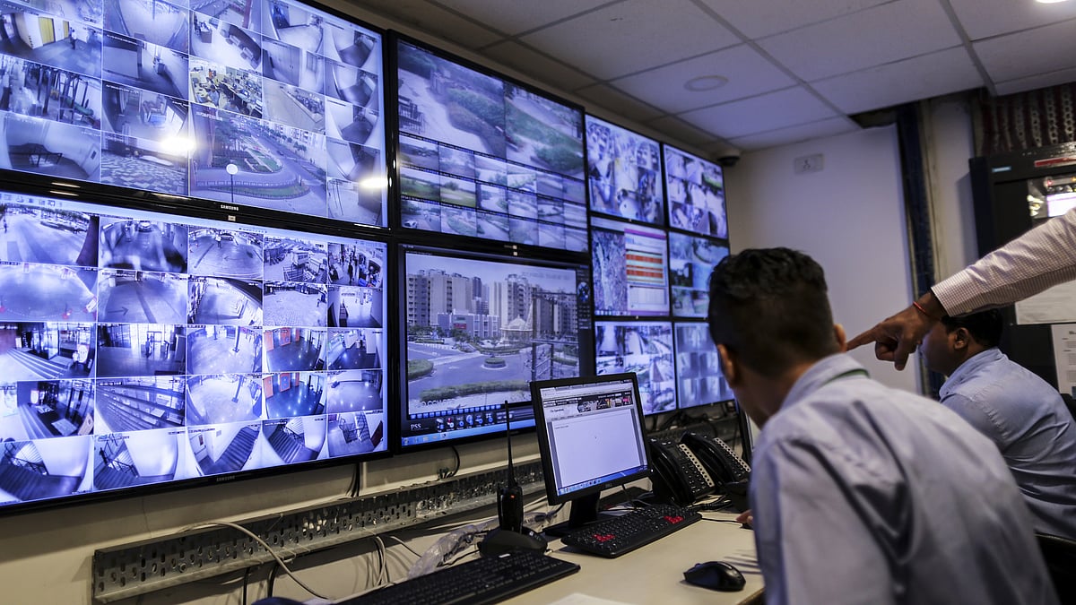 Staff monitor screens showing CCTV footage on the outskirts of Mumbai. (Photographer: Dhiraj Singh/Bloomberg)