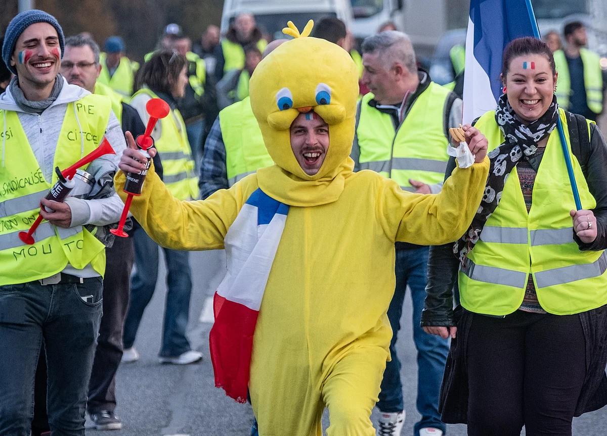 Macron Blinks as Yellow-Vests Protest Forces Fuel-Tax Climbdown