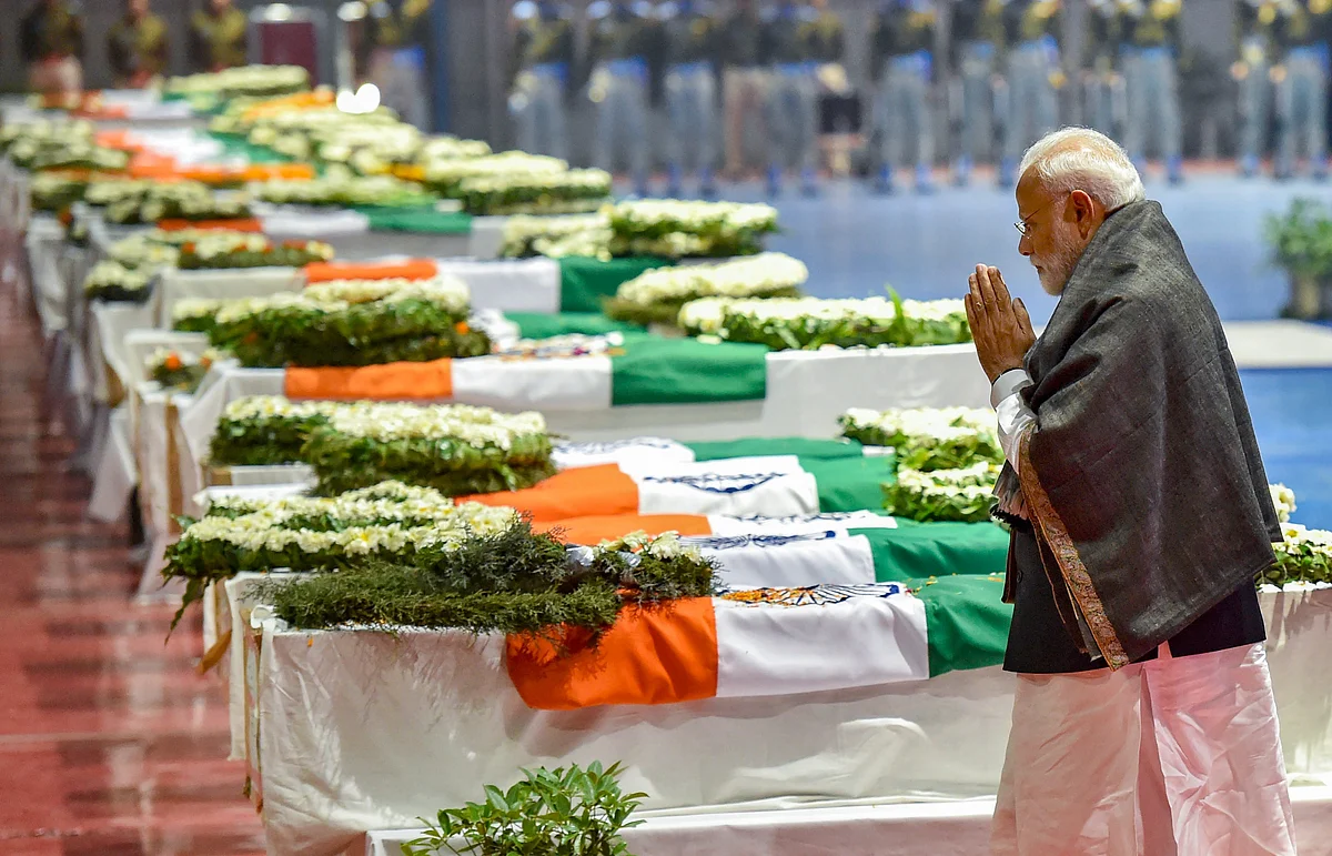 Prime Minister Narendra Modi pays tribute to the martyred CRPF jawans, who lost their lives in Thursday’s Pulwama terror attack, after their mortal remains were brought at AFS Palam in New Delhi. (PTI Photo) 