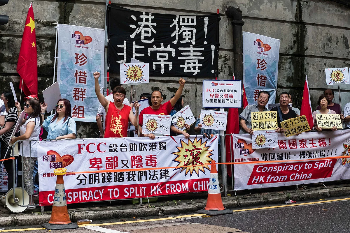 Pro-China protesters hold banners during a demonstration outside the Foreign Correspondents’ Club in Hong Kong, on Aug. 14, 2018. (Photographer: Billy H.C. Kwok/Bloomberg)