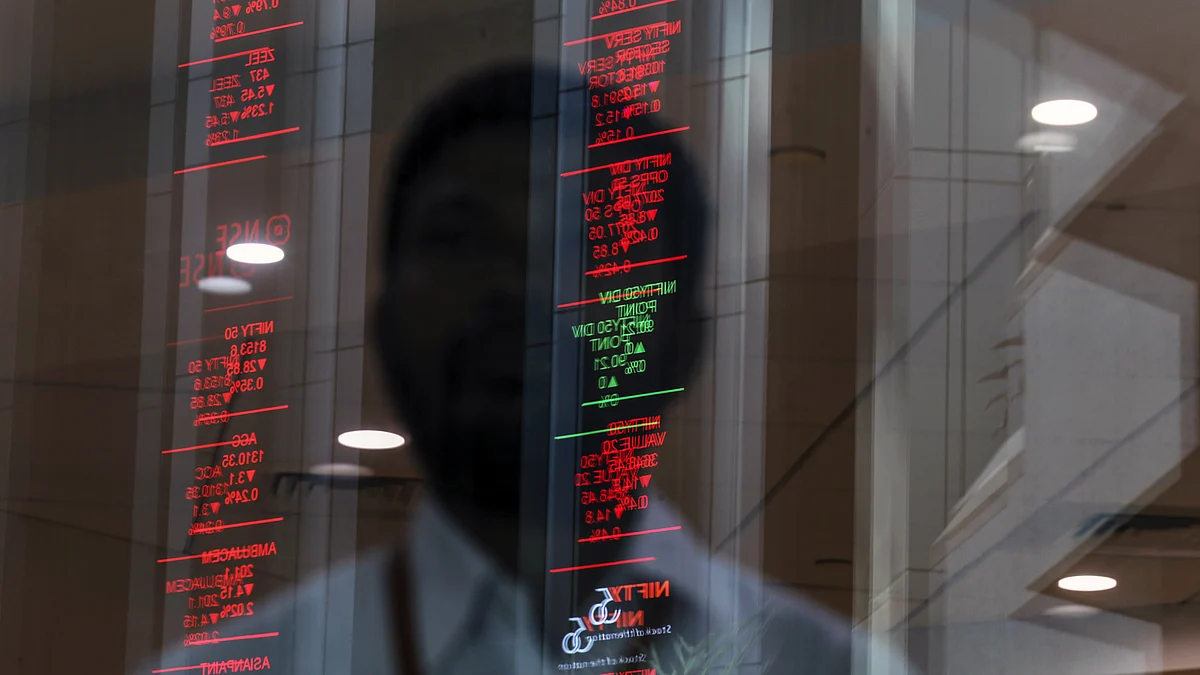 Electronic board indicating stock figures are reflected in a glass facade at the NSE in Mumbai. (Photographer: Dhiraj Singh/Bloomberg)