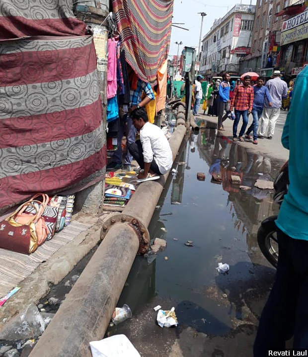 Sewage flows along the ghats of Varanasi. The city has only half the sewage lines it needs, government data show.
