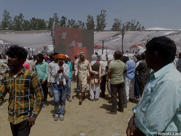 People watch Prime Minister Narendra Modi on a screen as he speaks at a gathering of more than 200,000 people in Uttar Pradesh’s Hardoi town. Two-and-a-half centuries after the British annexed Awadh citing Muslim misrule, Modi makes out a case of opposition misrule in the region.