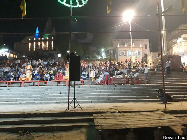 Devotees gather to watch the evening <em>aarti</em> or prayers, on the ghats alongside the Ganga.