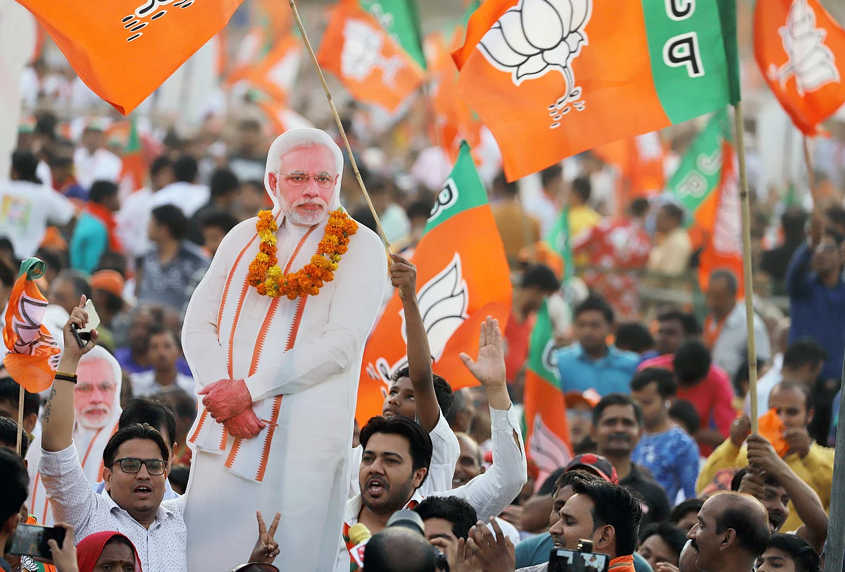 BJP supporters hold up a cardboard cutout of Prime Minister Narendra Modi at a rally in New Delhi, on May 8, 2019. (Photographer: Anindito Mukherjee/Bloomberg)