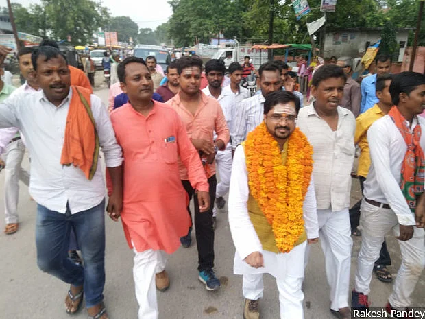 Rakesh Pandey (in white) participates in a rally in Uttar Pradesh’s Kushinagar taken out to mark his initiation into the Bharatiya Janata Party’s (BJP) IT cell. At age five, Pandey moved 840-km to his uncle’s home to be able to study under a lamp. Moved by Anna Hazare’s 2011 anti-corruption movement, he joined politics: He chose not the Aam Aadmi Party, but the BJP. (Photographer: Rakesh Pandey)