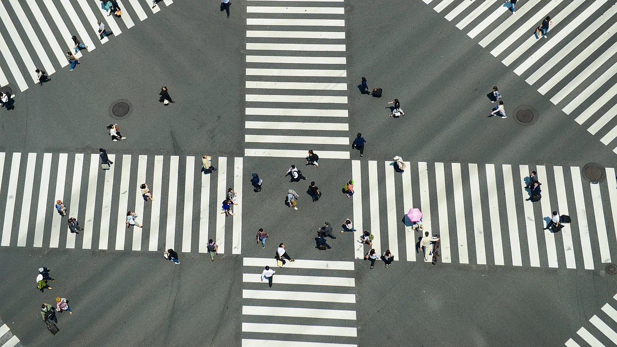 Pedestrians cross a road. (Photographer: Noriko Hayashi/Bloomberg) 