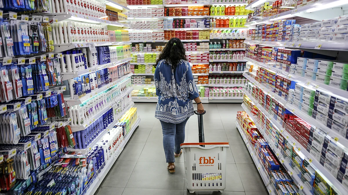 A shopper walks through an aisle displaying personal care goods at a hypermarket. (Photographer: Dhiraj Singh/Bloomberg) 