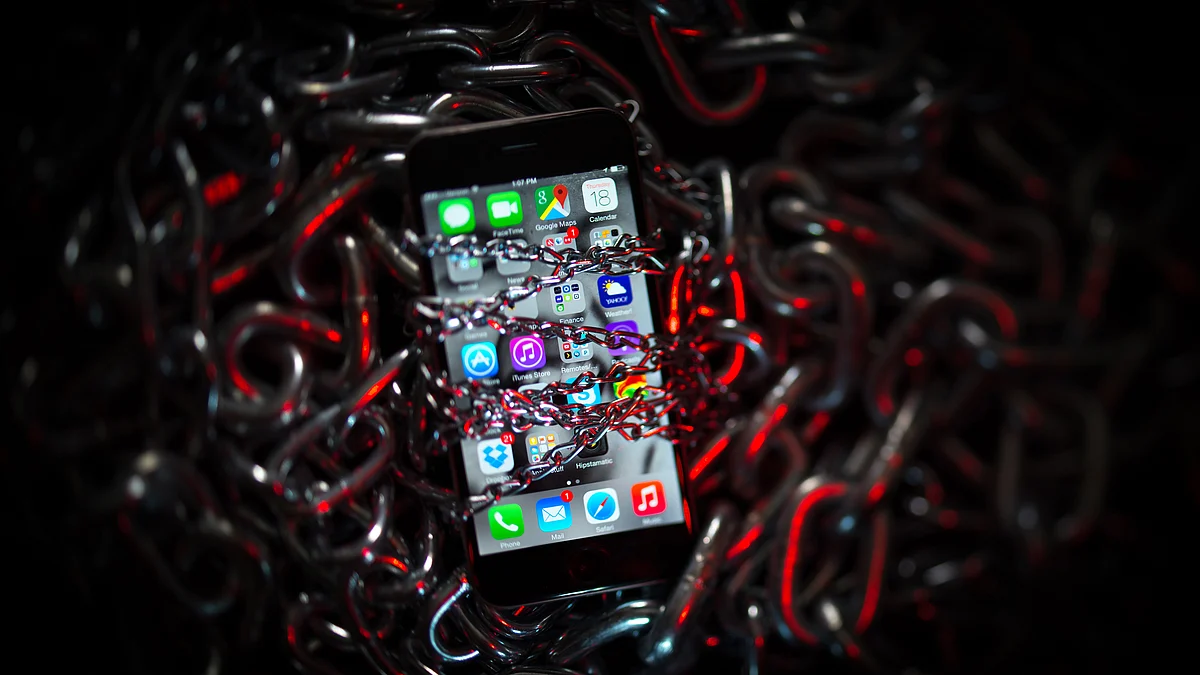 An iPhone is covered with chains in this arranged photograph. (Photographer: Craig Warga/Bloomberg)