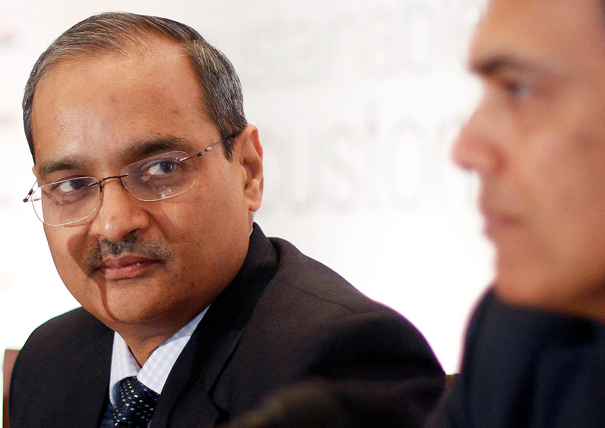 Seshagiri Rao, left, looks at Sajjan Jindal, chairman at JSW Steel Ltd. in this file photograph. (Photographer: Dhiraj Singh/Bloomberg)